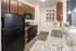 Modern kitchen with sleek black appliances, granite countertops, and ample storage space, ideal for culinary adventures and entertaining.