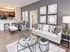 Modern living room with elegant decor, stylish furniture, and open-concept kitchen boasting sleek bar seating.