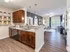 Contemporary apartment interior showcasing a sleek kitchen with granite countertops, open-plan living area with elegant decor, and abundant natural light from large patio doors.