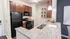 Modern kitchen with granite countertops, sleek appliances, and stylish wooden cabinets, offering a bright and inviting space.