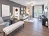 Elegant living room with stylish sofa, modern decor, and large windows offering natural light.