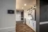 Elegant caf&eacute; area with modern white cabinetry, stylish lighting, and sleek wooden flooring.