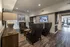 Chic modern lounge area with elegant armchairs, a stylish wood console, and inviting lighting set on sleek hardwood floors, perfect for relaxation and socializing.