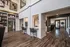 Elegant apartment interior featuring modern open-concept living with high ceilings, sleek wood flooring, and cozy seating areas.