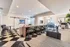 Modern communal area featuring stylish seating, sleek barn doors, geometric flooring, and abundant natural light.