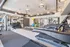 Modern fitness center featuring state-of-the-art treadmills, weightlifting equipment, and chic industrial lighting.