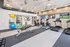 Modern fitness center with state-of-the-art equipment, bright lighting, and multiple flat-screen TVs, perfect for an invigorating workout.
