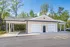 Modern residential building with two-car garages and elegant exterior amid lush greenery, ideal for serene living.