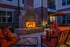Charming outdoor fireplace setting with cozy seating, perfect for relaxing evenings.