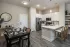 Open kitchen and dining area with island seating and modern finishes at Abberly Royal Creek in Raleigh, NC.