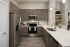 Modern kitchen with stainless steel appliances, gray cabinetry, and white countertops at Abberly Royal Creek in Raleigh, NC.