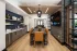 Community makerspace with high-top tables, cabinetry, and wall-mounted TV at Abberly Royal Creek in Raleigh, NC.