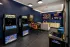 Arcade room with classic gaming machines and lounge seating at Abberly Royal Creek in Raleigh, NC.