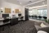 Business center with workstations, lounge seating, and meeting area at Abberly Royal Creek in Raleigh, NC.