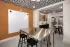 Resident clubroom with communal dining table, beverage station, and modern finishes at Abberly Royal Creek in Raleigh, NC.