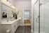 Guest bathroom with vanity and subway tile tub-shower surround at Abberly Royal Creek in Raleigh, NC.