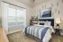 Secondary bedroom with large window and modern decor at Abberly Royal Creek in Raleigh, NC.