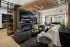 Resident lounge with fireplace, large TV, and billiards room access at Abberly Royal Creek in Raleigh, NC.