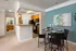 Inviting dining area with modern decor and open access to a stylish kitchen, showcasing elegant lighting and a comforting atmosphere.