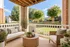 Charming apartment patio with cozy seating, lush greenery, and a serene garden view, perfect for relaxation and outdoor enjoyment.