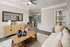 Contemporary living room showcasing elegant decor, cozy seating, and an open view to a chic dining area and modern kitchen.