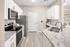 Modern kitchen featuring sleek granite countertops, stainless steel appliances, and elegant white cabinetry with ample storage.