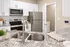 Modern kitchen with elegant granite countertops, stainless steel appliances, and sleek white cabinetry.