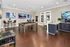 Inviting recreational room featuring a modern pool table, chic bar area, and vibrant artwork, perfect for entertainment and relaxation.