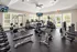 Modern fitness center featuring state-of-the-art gym equipment, bright windows, and a sleek design for an invigorating workout experience.