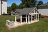 Charming outdoor pavilion with barbecue area, perfect for entertaining in a lush green setting.