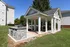 Charming outdoor pavilion with stone grill and picnic area, perfect for relaxation and social gatherings.