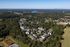 Scenic aerial view of a vibrant residential community surrounded by lush greenery and serene landscapes.