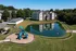 Charming apartment complex with scenic pond view and vibrant playground, offering a delightful balance of nature and family-friendly amenities.