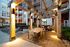 Elegant apartment courtyard with inviting outdoor seating, modern pergola, and ambient lighting, perfect for relaxation or social gatherings.
