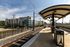 Modern apartment complex adjacent to a scenic railway station with urban architectural design and vibrant city views.