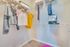 Bright and spacious walk-in closet featuring neatly organized clothing and ample shelving, perfect for maximizing storage in a modern apartment.
