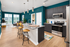 Modern open-concept kitchen and living area with sleek granite countertops, stylish pendant lighting, and large windows offering abundant natural light.