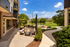 Chic outdoor patio with modern seating, fire pit, and lush greenery creating a relaxing retreat.