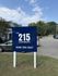 Inviting entrance to The 215 Apartments, set amidst lush greenery and featuring ample parking. Contact us at (629) 294-3647.