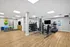 Modern fitness center with state-of-the-art gym equipment, vibrant exercise balls, and a spacious workout area.