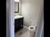 Chic bathroom featuring elegant black and white hexagonal tiles, a stylish vanity, and modern lighting.