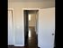 Inviting hallway with elegant wooden flooring and open doorways leading to sunlit rooms, offering a glimpse of spacious living.