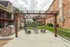 Charming outdoor patio area with stylish pergola, contemporary seating, and built-in barbecue, perfect for entertaining and relaxation.