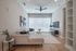 Bright and modern living room with a cozy sectional sofa, stylish decor, and large windows enhancing natural light.