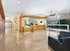 Elegant and modern lobby area featuring polished flooring, a sleek reception desk, and comfortable seating with a view of lush greenery.