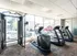 Modern fitness center with state-of-the-art exercise equipment, including treadmills and weight machines, designed for a refreshing workout experience.