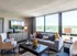 Bright and inviting living room with modern decor, plush seating, large window with scenic views, and stylish accents.