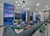 Chic modern lounge with plush seating, contemporary lighting, and expansive city views at sunset.