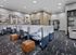 Modern office space with sleek workstations, stylish seating, and contemporary art on the walls.