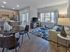 Stylish open-plan living room and kitchen with modern furniture and decor.